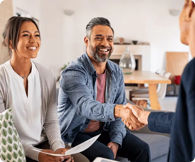 A couple shaking hands with a financial adviser after seeking financial advice.