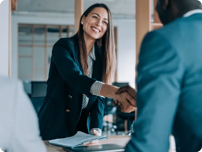 Two people meeting and shaking hands to discuss the changes within the financial advice sector.