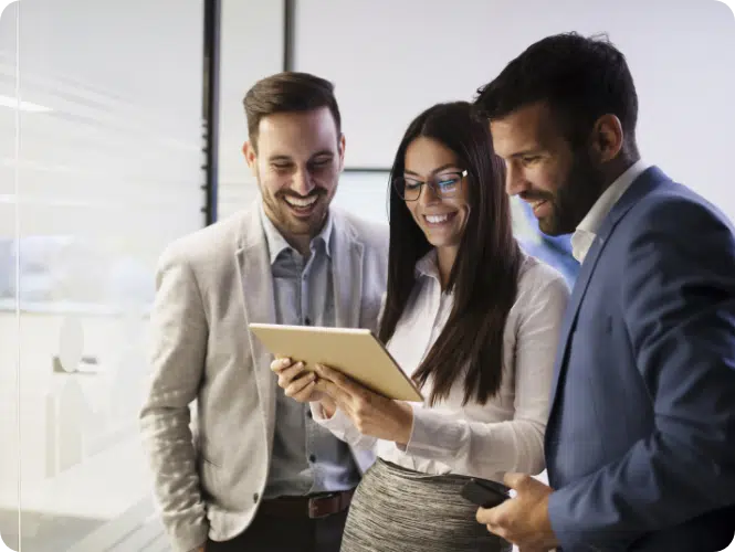 Robust rebalancing technology: a defense against ongoing market volatility? Two men and one woman standing and looking at a tablet