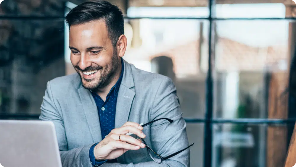 Man working at laptop and smiling