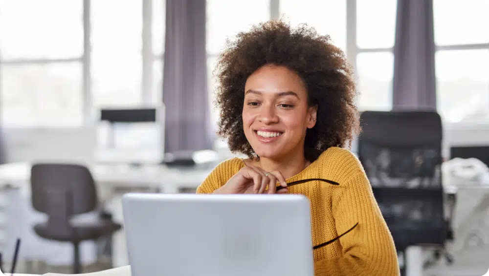 women smiling at laptop