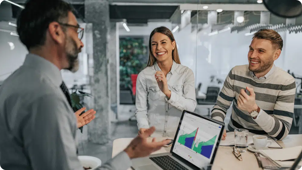 man presenting graphs to colleagues