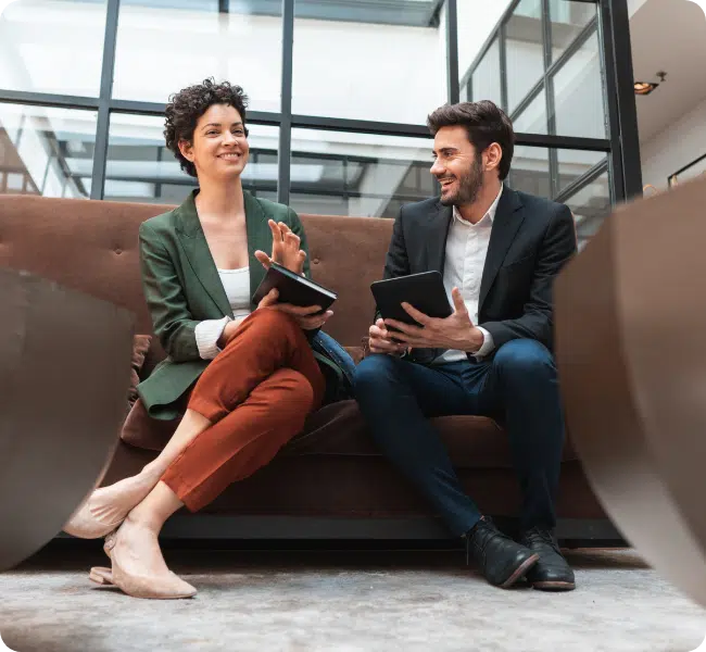 colleagues working from tablet devices and smiling