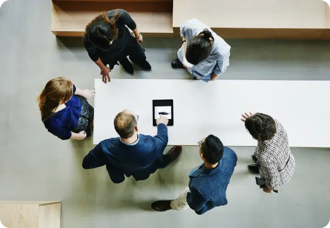 Employees having a standing meeting, representing who intelliflo is as a company.