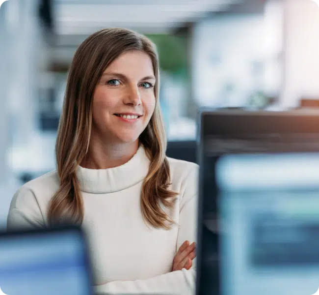 Woman smiling at the camera with arms folded